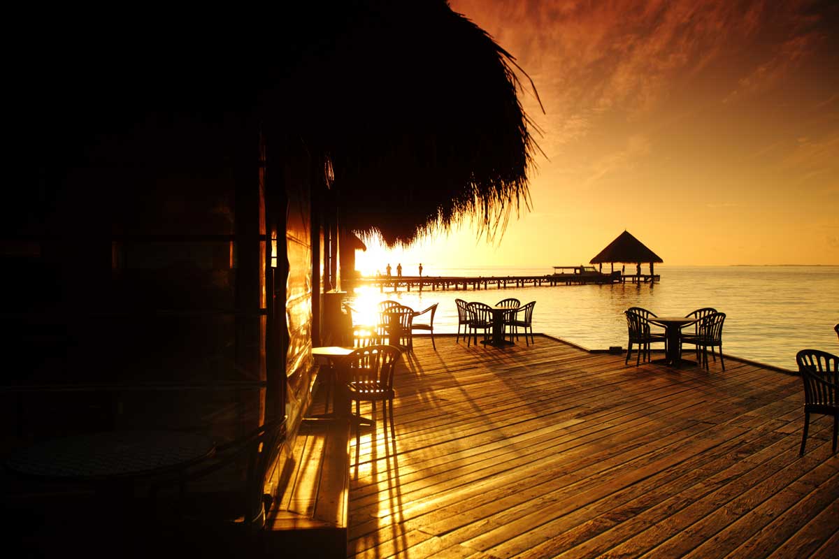 Der Sonnenuntergang über dem Meer spiegelt sich in einer Villa