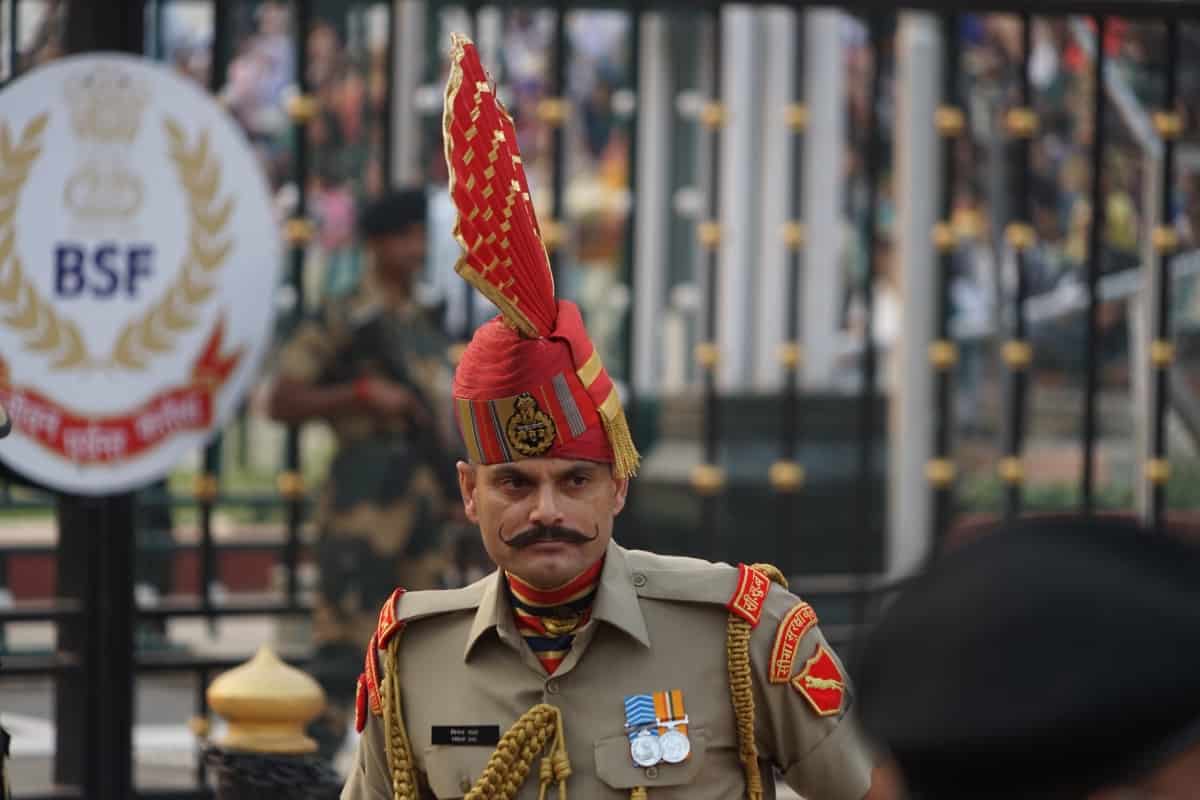 Nahaufnahme eines indischen Soldaten bei der Attari–Wagah border ceremony. Der Mann trägt einen Roten Kopfschmuck, der ihn wie ein Irokese höher wirken lässt