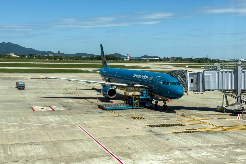 Ein blaues Passagierflugzeug der Vietnam Airlines, das an einem Flugsteig geparkt ist.